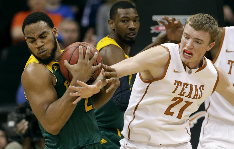 Texas' Connor Lammert (21) tries to steal the ball from Baylor's Rico Gathers, left, during the second half of an NCAA college basketball game in the Big 12 men's tournament Friday, March 14, 2014, in Kansas City, Mo. Baylor won 86-69. (AP Photo/Charlie Riedel)