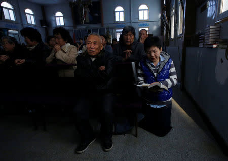 FILE PHOTO: Believers take part in a weekend mass at an underground Catholic church in Tianjin November 10, 2013. REUTERS/Kim Kyung-Hoon File Photo