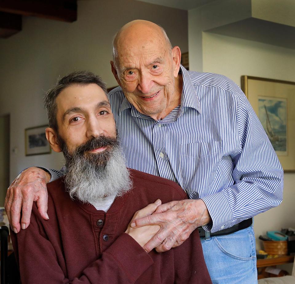 Carmine "Charlie" Charlie Mazzulli, 95, right, is the main caregiver for his son, Bob, 53, who suffered a spinal cord injury 10 years ago.