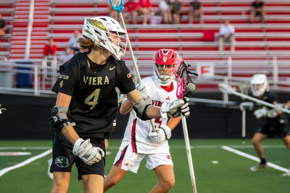 Viera’s Landon Almonte (4) protects the ball from Vero Beach’s Brandon Cochrane (5) in a high school lacrosse District 8-2A championship match at Vero Beach on Monday, April 15, 2024.