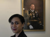 Tonga High Commissioner to the UK, Titilupe Fanetupouvava'u Tu'ivakano poses for a photograph in front of a portrait of the King of Tonga Tupou VI during an interview with The Associated Press, at the High Commission in London, Monday, May 30, 2022. As well as celebrating Queen Elizabeth II’s Platinum Jubilee, Tu’ivakano will also remember her great- grandmother Queen Salote Tupou III, who endeared herself to Britons as she rode through the streets of London in an open carriage during Elizabeth’s coronation parade in 1953. (AP Photo/Alastair Grant)