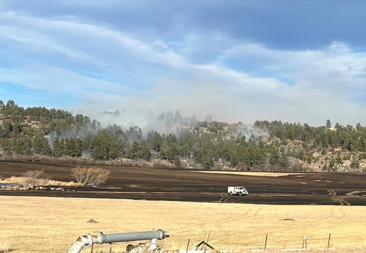 Crews continue to work on extinguishing the Old San Isabel Fire near Rye, which prompted school and residential housing evacuations on Monday.