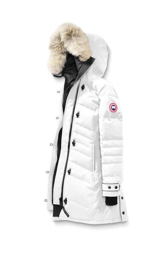 White parka with fur hood featuring Canada Goose oval logo on shoulder.