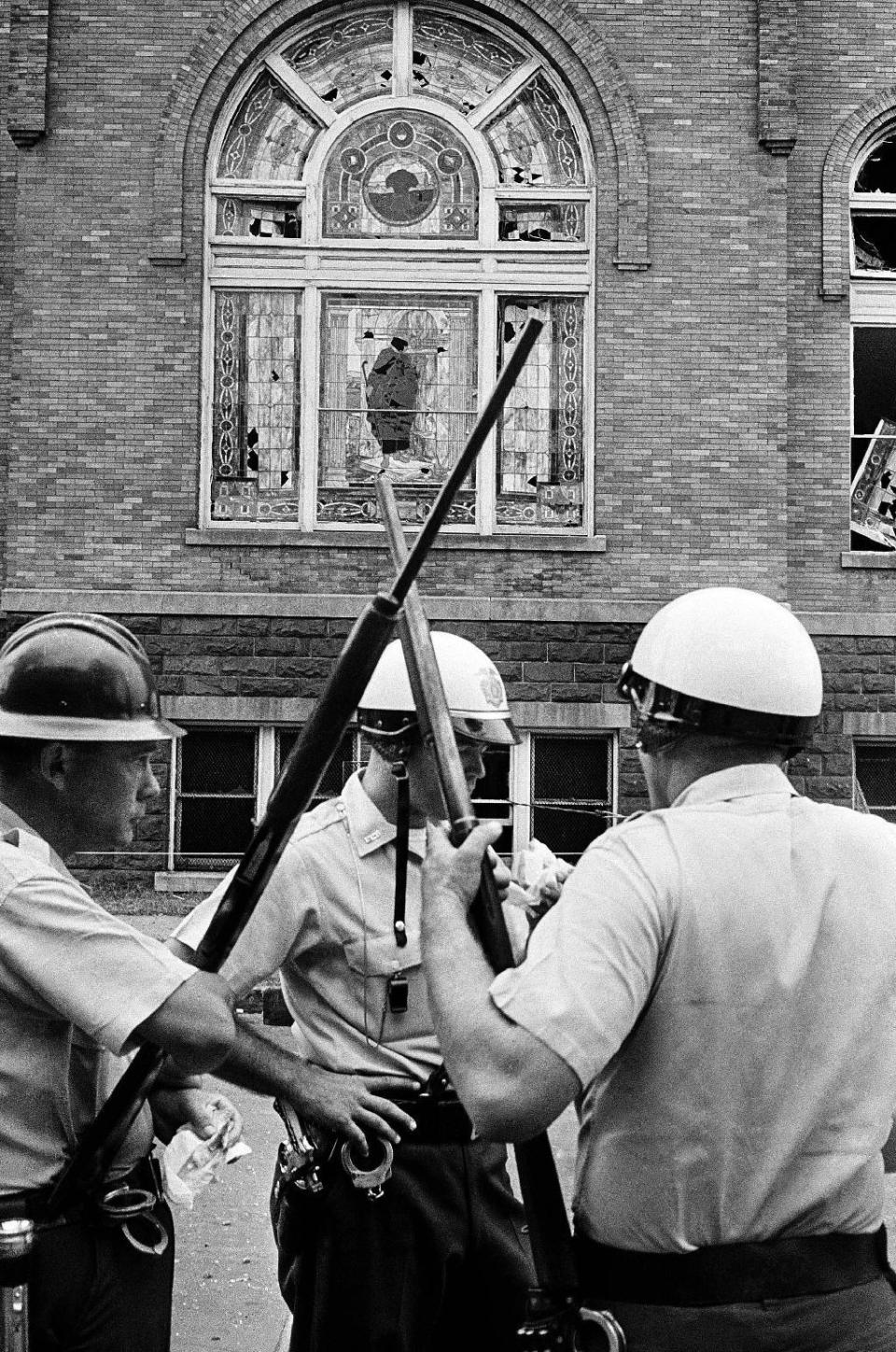 In this Sept. 15, 1963 photo, policeman stand guard outside the 16th Street Baptist Church in Birmingham, Ala., which was the scene of an explosion that killed four African American children. President Barack Obama signed an order Thursday, Jan. 12, 2017, designating an historic civil rights district in Birmingham as a national monument, placing several blocks of a city once rocked by racial violence on par with landmarks including the Grand Canyon. (AP Photo)