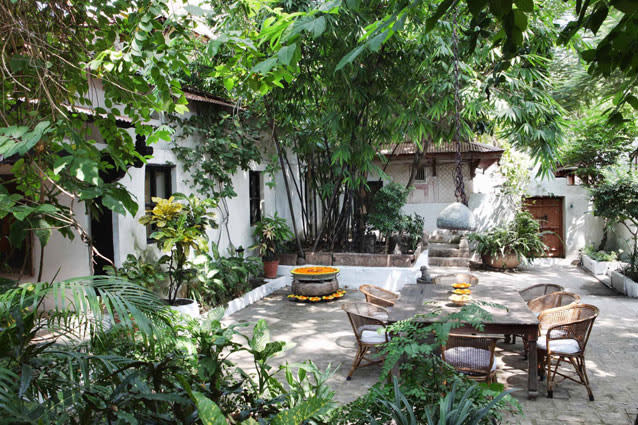 Ahilya Fort Maheshwar, Madhya Pradesh. Photo: Tom Parker - Whitewashed walls lined with royal images, bougainvillea-festooned courtyards and age-old bronze idols all tell stories of love, romance and valour. The hotel’s 13 rooms—including the spectacular Narmada Suite overlooking the river, and the Neem Suite that Maratha queen Ahilya Bai Holkar once occupied—have been restored using traditional textiles such as the Maheshwari and indigo block prints from Indore.