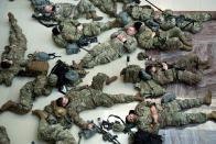 <p>Members of the National Guard rest in the Capitol Visitors Center on Capitol Hill in Washington, DC, January 13, 2021.</p>