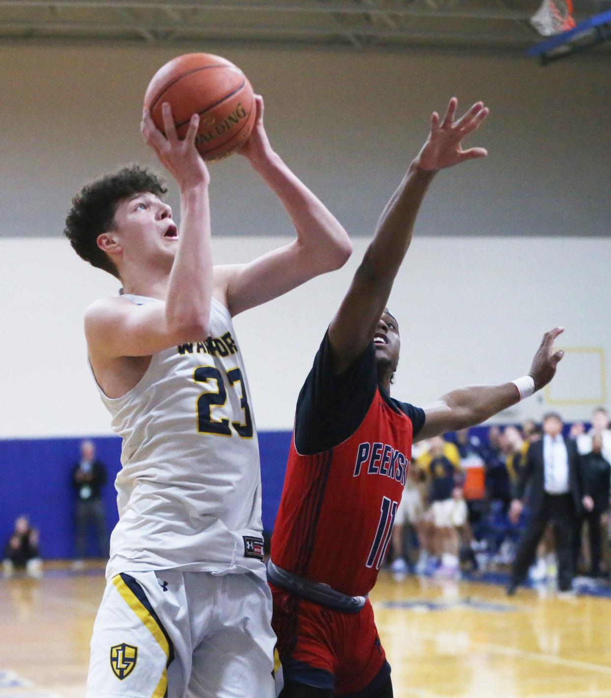 Lourdes' Zachary Hart goes to the net against Peekskill's Travis Brown during the New York State Class AA regional final on March 8, 2024.