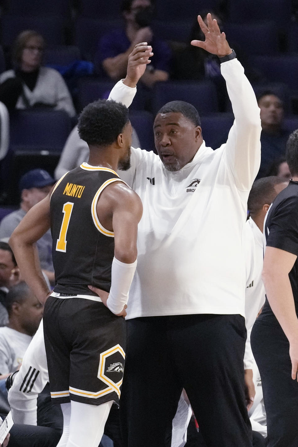 Western Michigan head coach Dwayne Stephens, right, talks to guard Brandon Muntu during the first half of an NCAA college basketball game against Northwestern in Evanston, Ill., Tuesday, Nov. 14, 2023. (AP Photo/Nam Y. Huh)