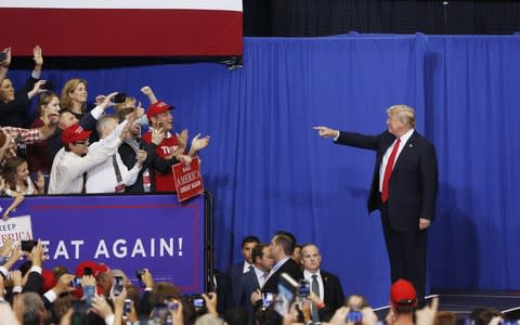 Donald Trump gestures to attendees as he arrives onstage at a rally in Nashville, Tennessee - Credit: Luke Sharrett/Bloomberg