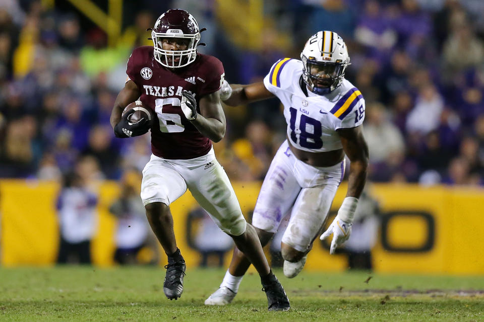 BATON ROUGE, LOUISIANA - NOVEMBER 27: Devon Achane #6 of the Texas A&amp;M Aggies runs with the ball as Damone Clark #18 of the LSU Tigers defends during the second half at Tiger Stadium on November 27, 2021 in Baton Rouge, Louisiana. (Photo by Jonathan Bachman/Getty Images)