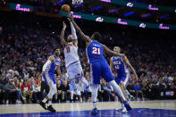 New York Knicks' Jalen Brunson (11) goes up for a shot against Philadelphia 76ers' Joel Embiid (21) during the first half of Game 3 in an NBA basketball first-round playoff series, Thursday, April 25, 2024, in Philadelphia. (AP Photo/Matt Slocum)