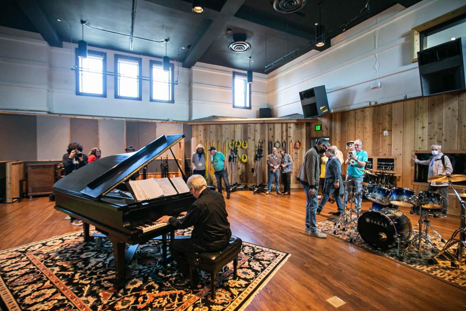 A tour group walks through The Church Studio to view exhibits created in the renovated Tulsa church, which was originally built in 1915 as Grace Methodist Episcopal Church.