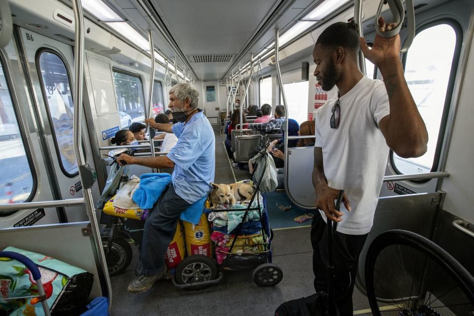 Augustine Hurtado, with his dog Sparky on board his scooter, exits a Metro train.