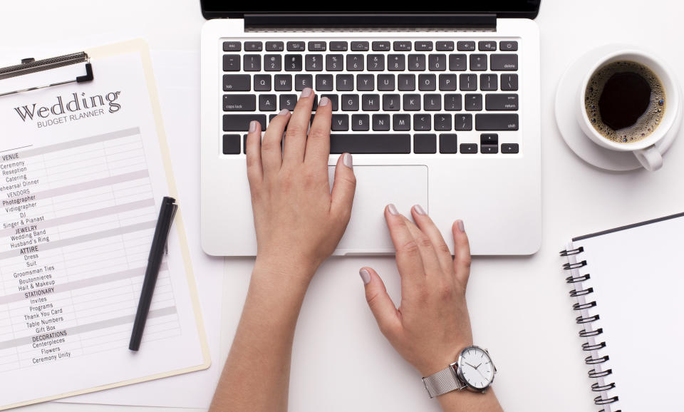 Wedding budget planning. Woman searching prices on laptop through the internet