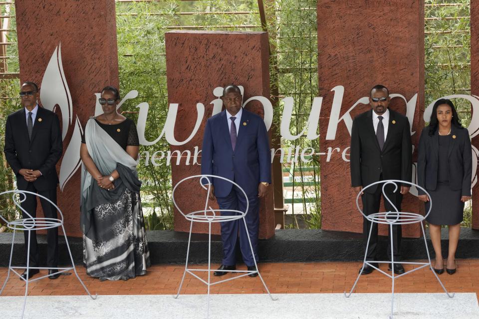 Rwandan President Paul Kagame, left and his wife, first lady Jeannette Kagame, President of the Central African Republic Faustin-Archange Touadérale, centre and Ethiopia's Prime Minister Abiy Ahmed and his wife Zinash Tayachew stand, during a ceremony to mark the 30th anniversary of the Rwandan genocide, held at the Kigali Genocide Memorial, in Kigali, Rwanda, Sunday, April 7, 2024. Rwandans are commemorating 30 years since the genocide in which an estimated 800,000 people were killed by government-backed extremists, shattering this small east African country that continues to grapple with the horrific legacy of the massacres. (AP Photo/Brian Inganga)