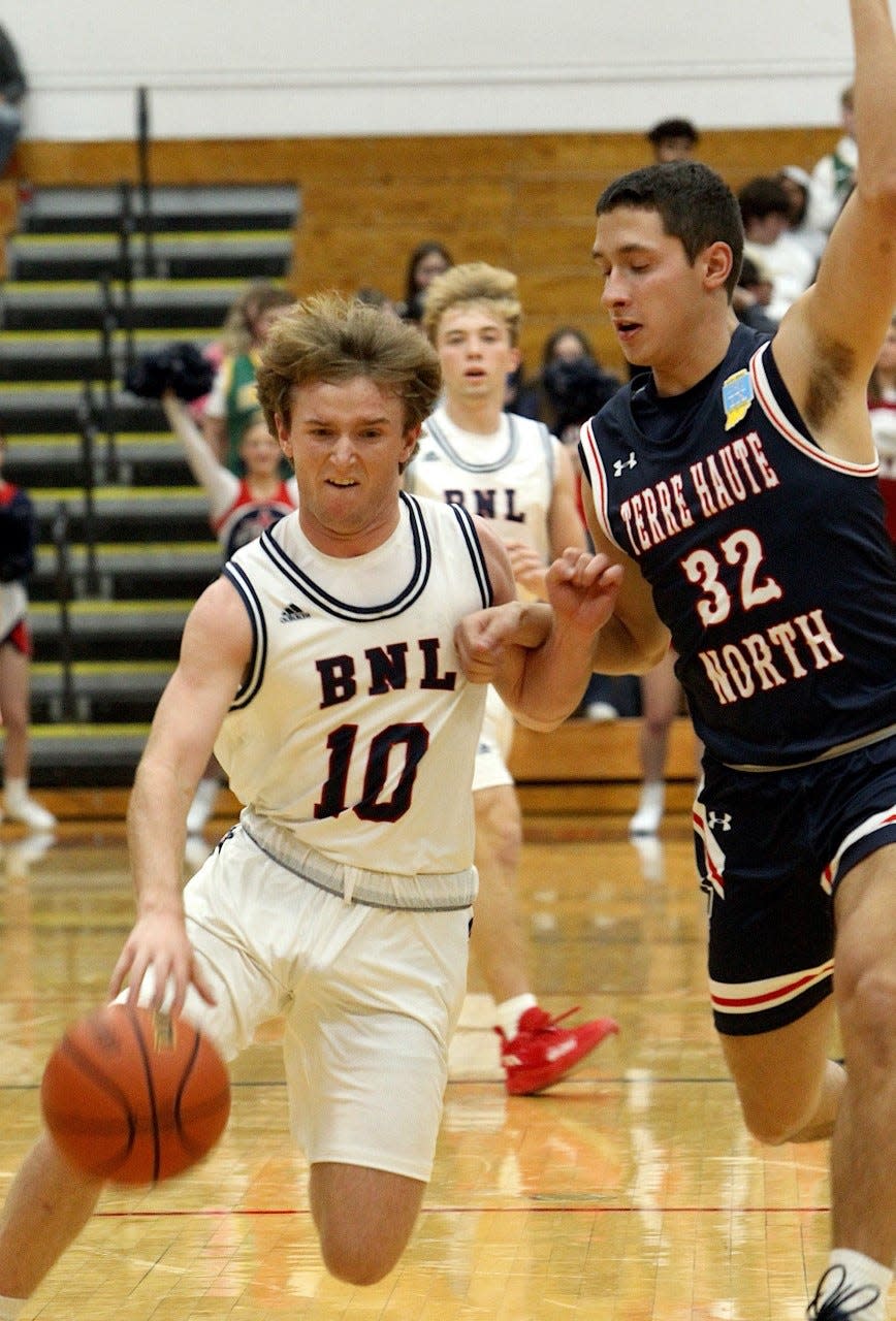 BNL junior guard Dylan Nikirk drives on Terre Haute North's Issac Ross Saturday night in a 45-37 setback at BNL Fieldhouse.