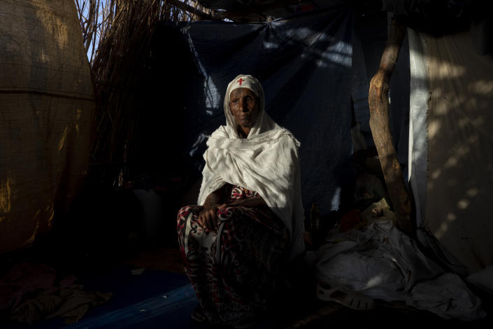 Tigrayan refugee Maza Girmay, 65, sits in her shelter, in Hamdayet, eastern Sudan, near the border with Ethiopia, on March 15, 2021. "I heard food was being distributed," she said. She went to the government office in her community of Bahkar to inquire. "They told me, 'Go home, you're Tigrayan.'" The rejection brought her to tears. "We Tigrayans are Ethiopian. Why do they treat us as non-Ethiopian?" she said. (AP Photo/Nariman El-Mofty)