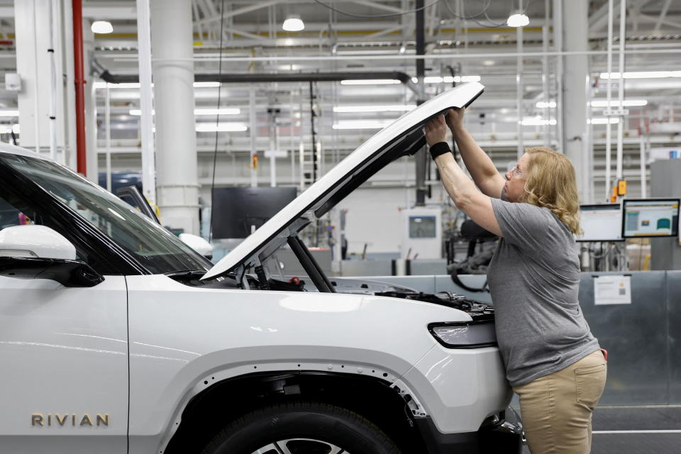 An employee works on an assembly line at startup Rivian Automotive's electric vehicle factory in Normal, Illinois, U.S. April 11, 2022. Picture taken April 11, 2022.  REUTERS/Kamil Krzaczynski