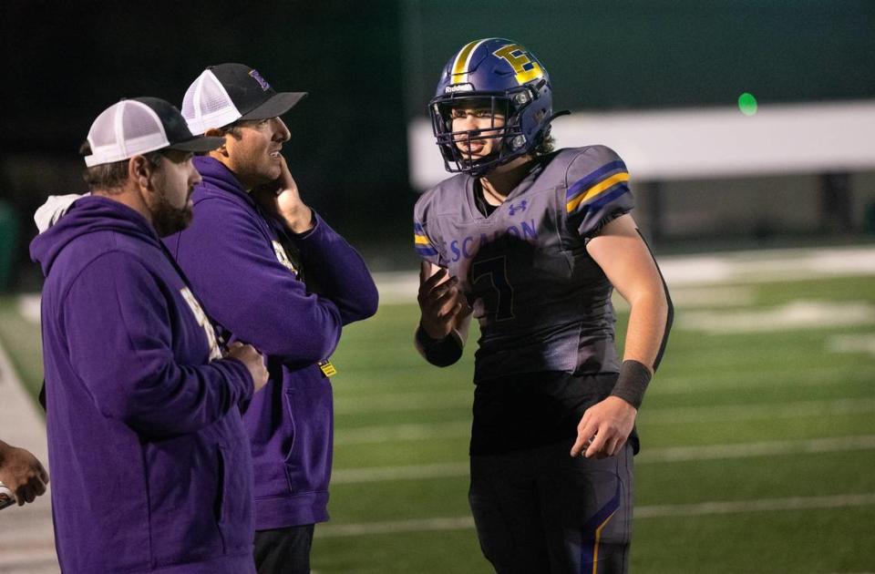 Escalon quarterback Donovan Rozevink, right, talks with coach Andrew Beam, middle, during the Sac-Joaquin Section Division IV championship game with Patterson at St. Mary’s High School in Stockton, Calif., Friday, Nov. 24, 2023.