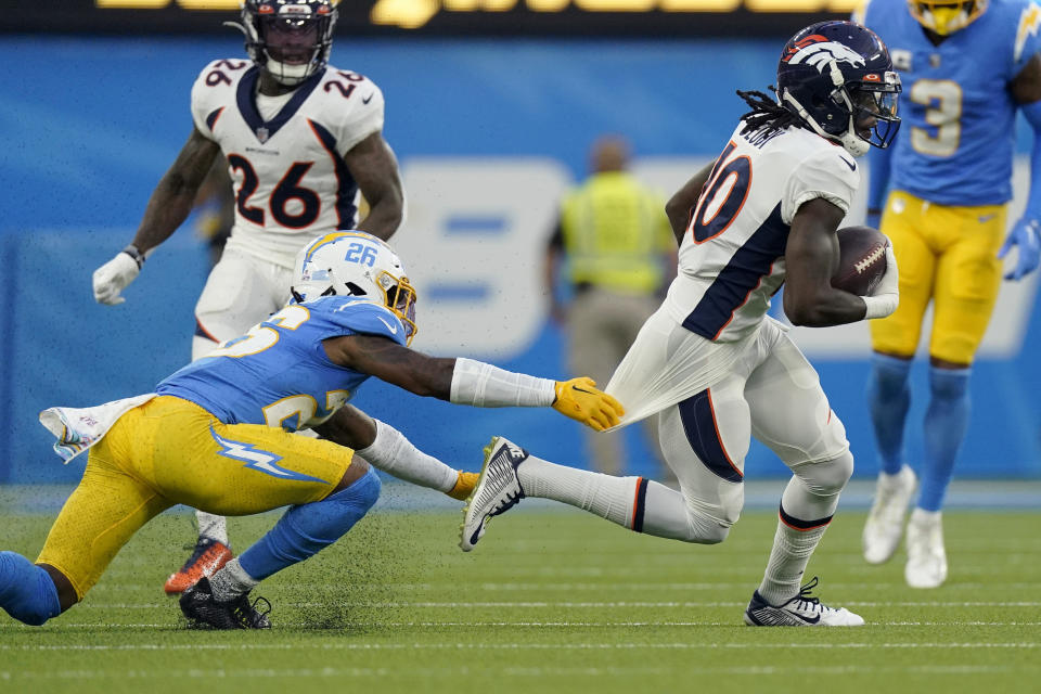 Los Angeles Chargers cornerback Asante Samuel Jr. (26) grabs the jersey of Denver Broncos wide receiver Jerry Jeudy during the first half of an NFL football game, Monday, Oct. 17, 2022, in Inglewood, Calif. (AP Photo/Mark J. Terrill)