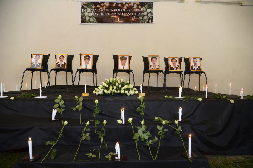 Mourners attended a memorial service held by an association of Ethiopian airline pilots, at which framed photographs of seven crew members were on display, in Addis Ababa, Ethiopia Monday, March 11, 2019. Authorities in Ethiopia, China and Indonesia grounded all Boeing 737 Max 8 aircraft Monday following the crash of an Ethiopian Airlines jetliner that killed 157 people, and investigators found the flight recorders from the field where the plane went down. (AP Photo/Samuel Habtab)