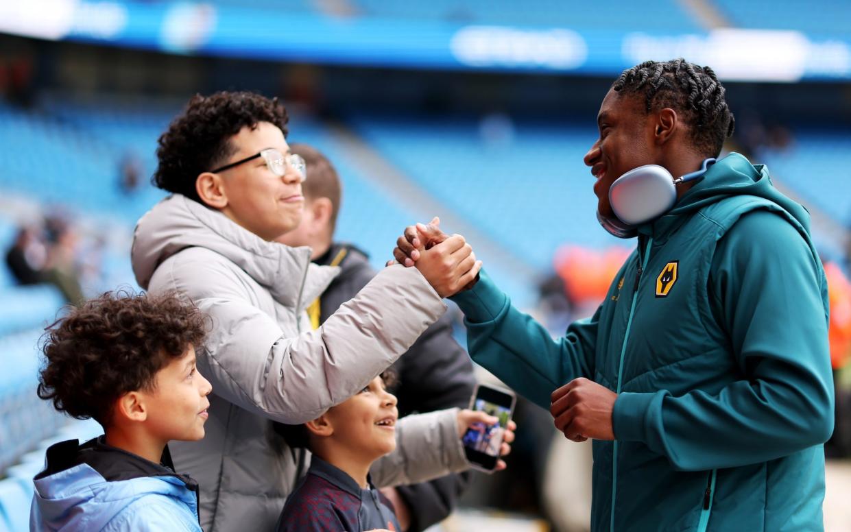 Jean-Ricner Bellegarde of Wolverhampton Wanderers interacts with fans