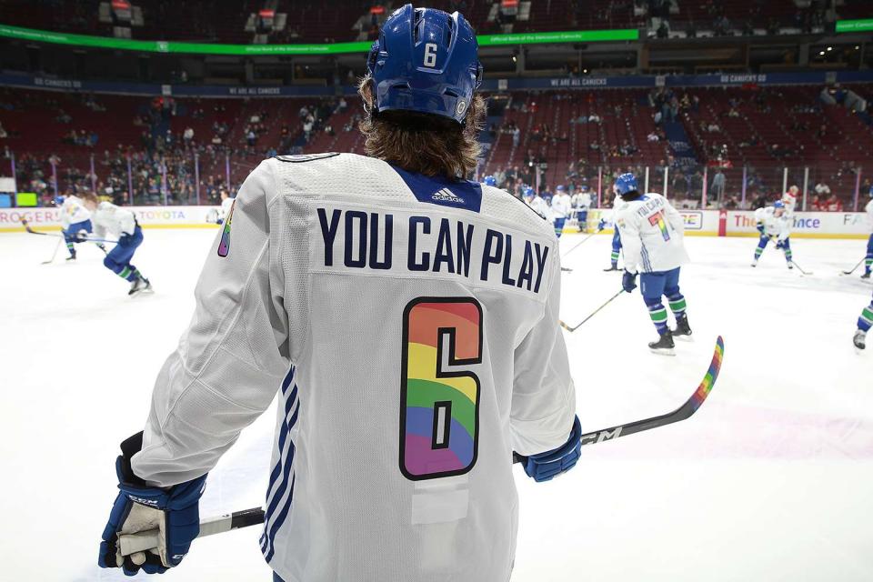 <p>Jeff Vinnick/NHLI via Getty</p> Vancouver Canucks team wears "You Can Play" Pride night jerseys