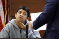 Former Marjory Stoneman Douglas High School student Anthony Borges, who was injured in the 2018 shootings, is shown a photograph while testifying during the trial of former Marjory Stoneman Douglas High School School Resource Officer Scot Peterson, Thursday, June 8, 2023, at the Broward County Courthouse in Fort Lauderdale, Fla. Peterson is charged with child neglect and other charges for failing to stop the Parkland school massacre five years ago. (Amy Beth Bennett/South Florida Sun-Sentinel via AP, Pool)