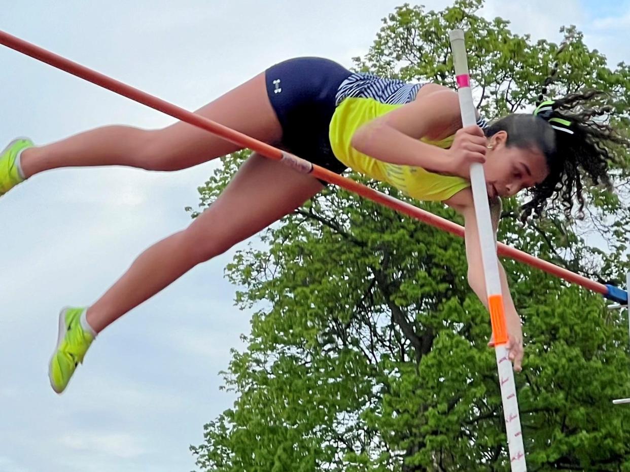 River Valley's Eva Moran successfully gets over the bar during the girls pole vault at the 74th Marion Night invitational at Marion Harding on Friday.