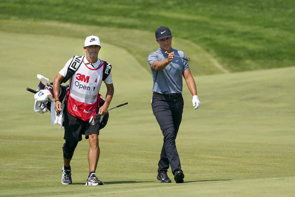 Cameron Champ, right, and caddie Chad Reynolds make their way up the 11th fairway during the final round of the 3M Open golf tournament in Blaine, Minn., Sunday, July 25, 2021. (AP Photo/Craig Lassig)