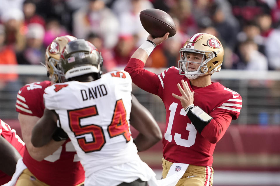 San Francisco 49ers quarterback Brock Purdy (13) passes against Tampa Bay Buccaneers linebacker Lavonte David (54) during the first half of an NFL football game in Santa Clara, Calif., Sunday, Dec. 11, 2022. (AP Photo/Tony Avelar)