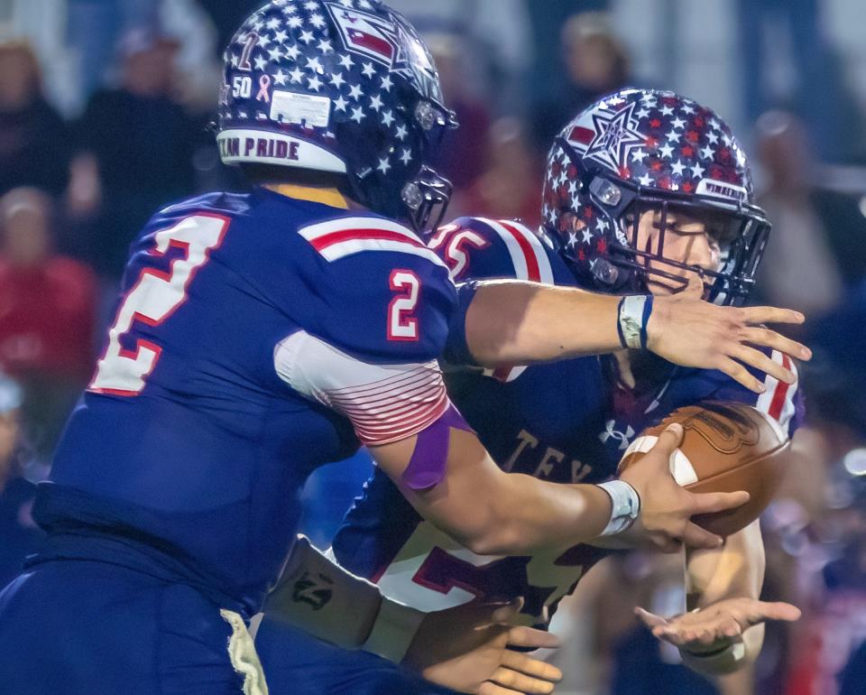 Wimberley running back Johnny Ball takes a fourth-quarter handoff during the Texans' regional final win over Lago Vista two weeks ago. After rushing for 677 yards and 10 touchdowns during the regular season, Ball's production has amped up in the playoffs: 722 yards and 10 scores in five games.