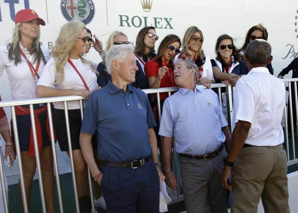 <p>Former Presidents, from left, Bill Clinton, George Bush and Barack Obama chat with wives of the U.S. team’s players before the first round of the Presidents Cup at Liberty National Golf Club in Jersey City, N.J., Thursday, Sept. 28, 2017. (AP Photo/Julio Cortez) </p>