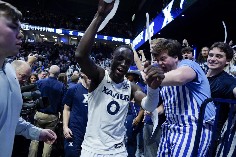 FILE - Xavier's Souley Boum (0) celebrates with fans after defeating Marquette in an NCAA college basketball game, Sunday, Jan. 15, 2023, in Cincinnati. Boum was named Big East newcomer of the year in voting released by The Associated Press Tuesday, March 7, 2023. (AP Photo/Jeff Dean, File)