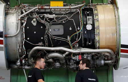 Technicians work on a Bombardier Global aircraft at the company's service centre at Biggin Hill, Britain March 5, 2018. REUTERS/Peter Nicholls