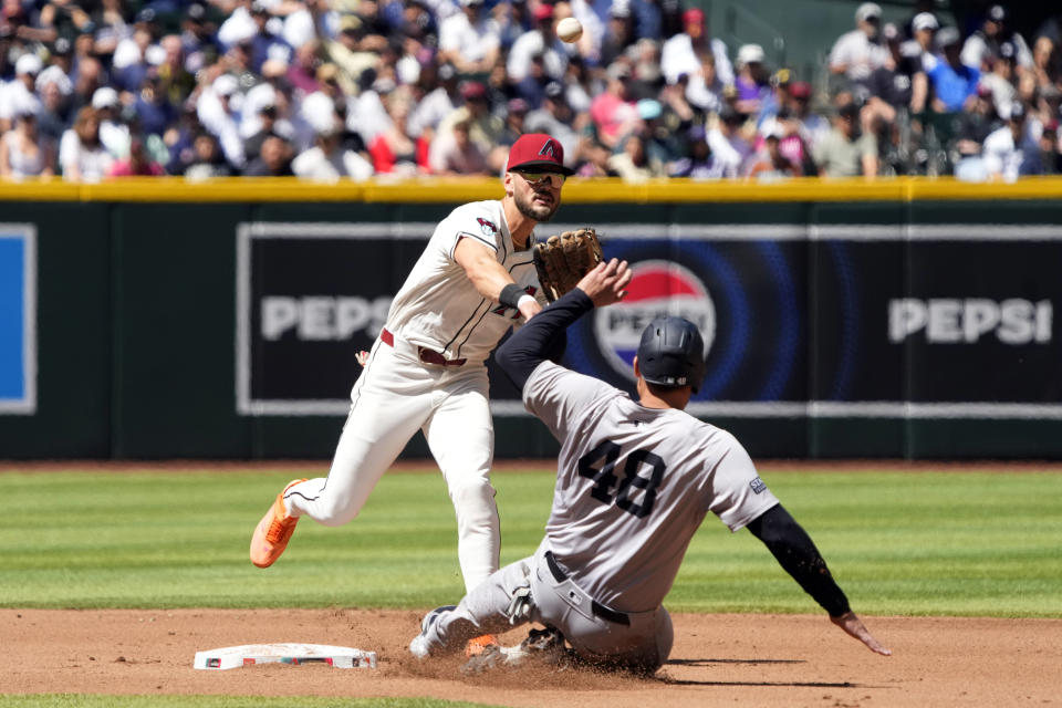Arizona Diamondbacks second baseman Jace Peterson gets the force out on New York Yankees' Anthony Rizzo (48) on a ball hit by Anthony Volpe in the fourth inning during a baseball game, Wednesday, April 3, 2024, in Phoenix. (AP Photo/Rick Scuteri)