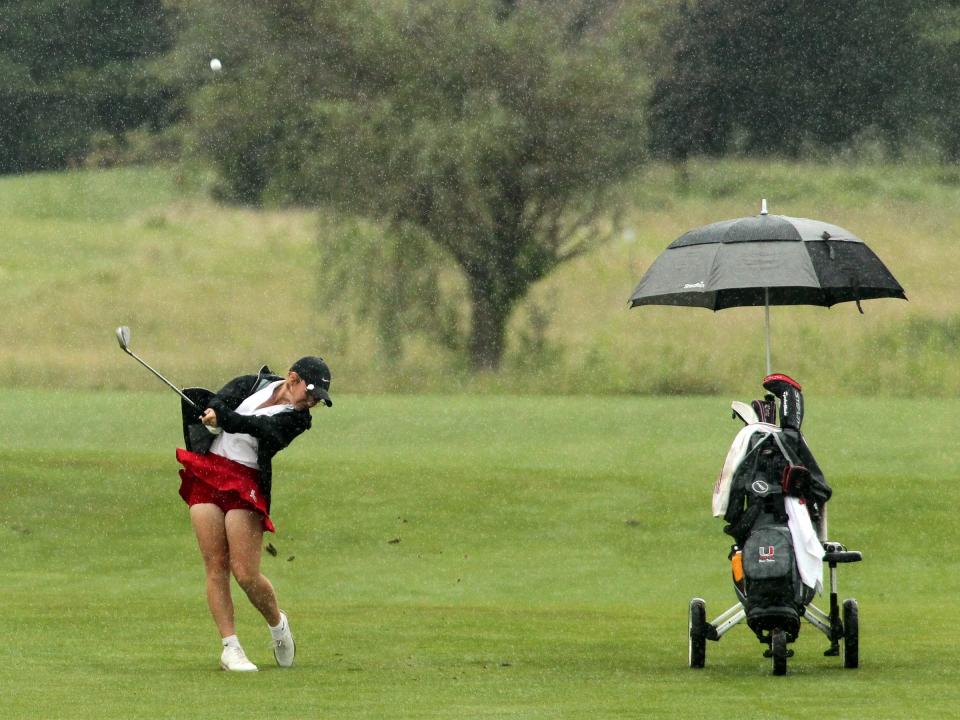 Utica's Olivia Dickson drives the ball in the rain on hole 8 during the Licking County League girls golf tournament at Cumberland Trail.