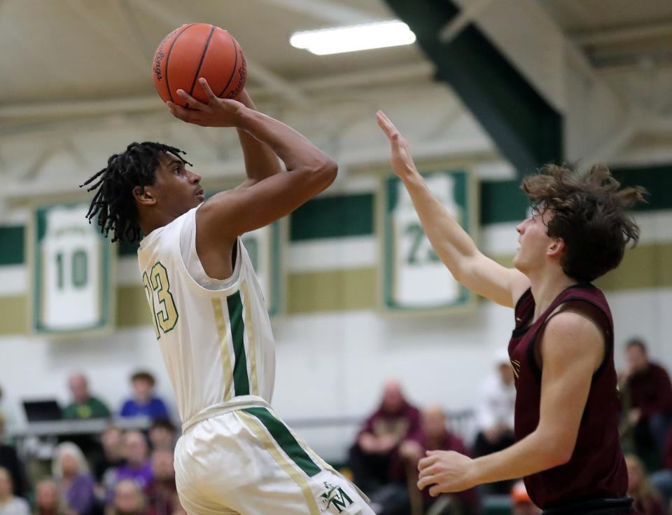 STVM's DeCarlo Prince, left, shoots over Stow's Andy Mergen during the first half of a high school basketball game, Tuesday, Jan. 30, 2024, in Akron, Ohio.