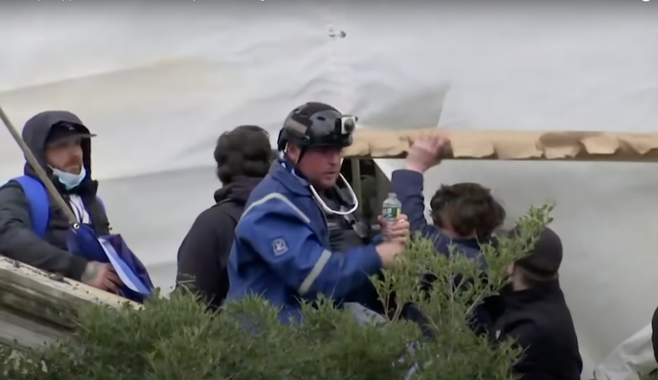 Court documents identified Guy Wesley Reffitt in this picture wearing a blue jacket and helmet with Go-Pro camera (YouTube/Reuters)