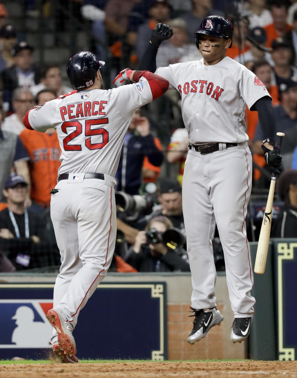 Boston Red Sox's Steve Pearce celebrates after his home run with Rafael Devers against the Houston Astros during the sixth inning in Game 3 of a baseball American League Championship Series on Tuesday, Oct. 16, 2018, in Houston. (AP Photo/David J. Phillip)