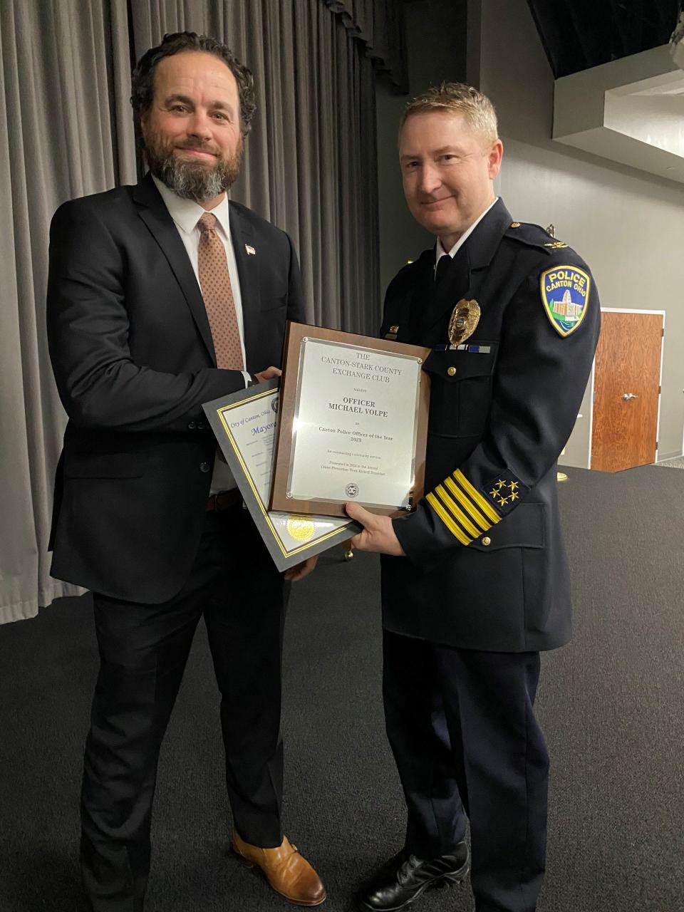 Canton Police Officer of the Year Michael Volpe, left, stands with Canton Police Chief John Gabbard at Wednesday's Crime Prevention Breakfast, at which Volpe was honored. The annual event is sponsored by the Exchange Club of Canton-Stark County.