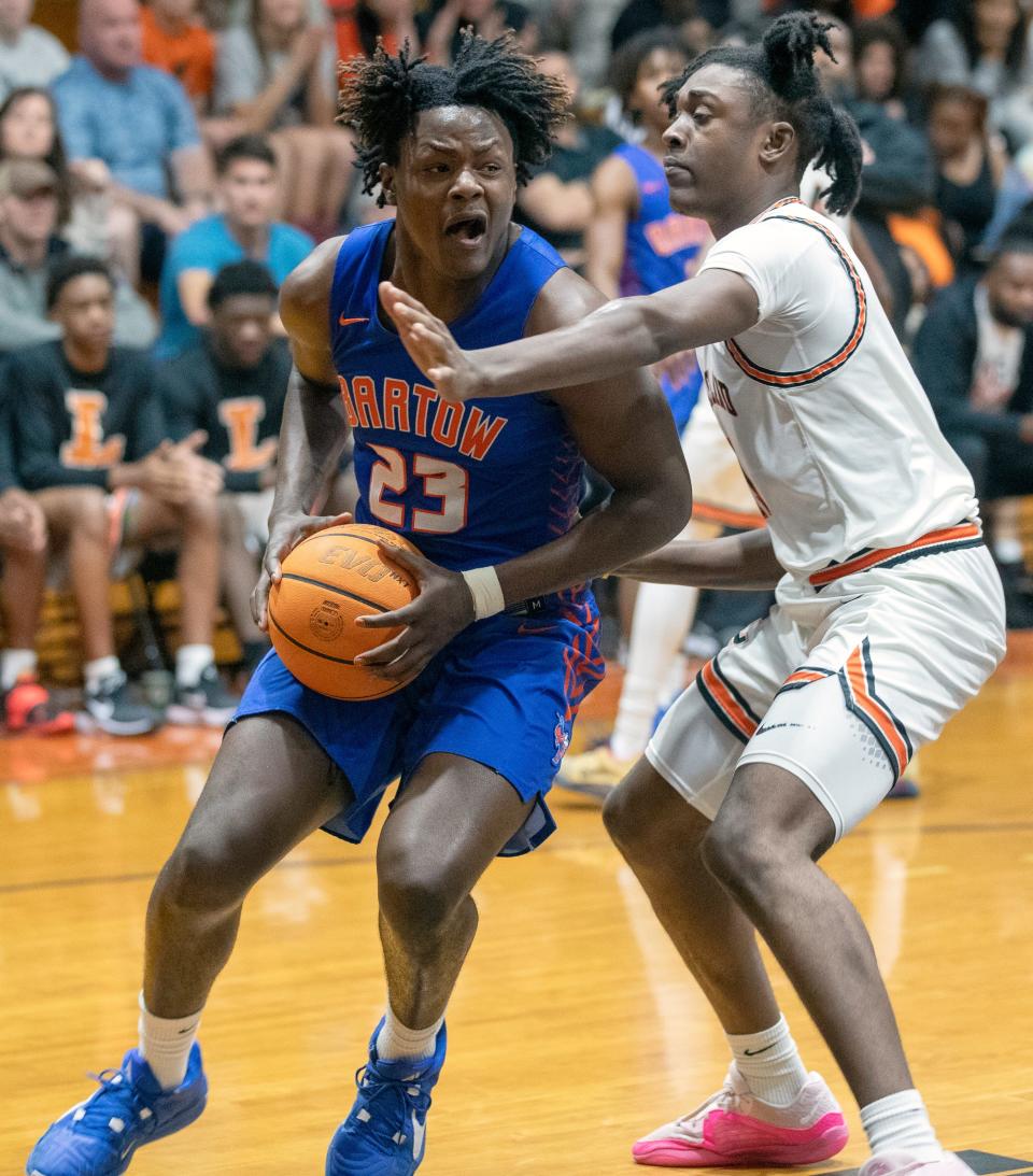 Bartow's Jayson Williams looks to pass against Lakeland on Saturday night in the championship game of the Class 6A, Distrct 7 boys basketball tournament.