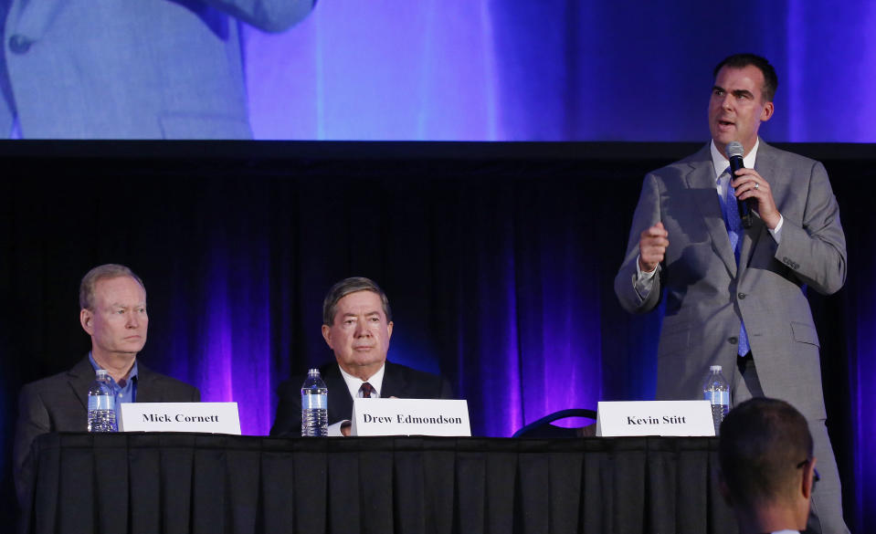 In this Friday, Aug. 24, 2018, photo Republican gubernatorial candidate Kevin Stitt, right, speaks during a candidate forum in Oklahoma City. At left is Republican candidate Mick Cornett, who Stitt will face in a runoff Tuesday, Aug. 28. At center is Democratic candidate Drew Edmondson, who will face the winner in November. (AP Photo/Sue Ogrocki)