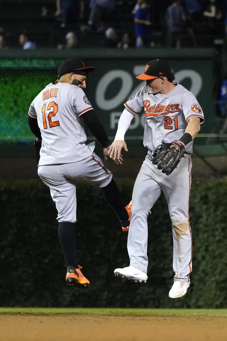 Baltimore Orioles' Rougned Odor (12) and Austin Hays celebrate the team's 7-1 win over the Chicago Cubs, the baseball club's 10th win in a row, Wednesday, July 13, 2022, in Chicago. (AP Photo/Charles Rex Arbogast)