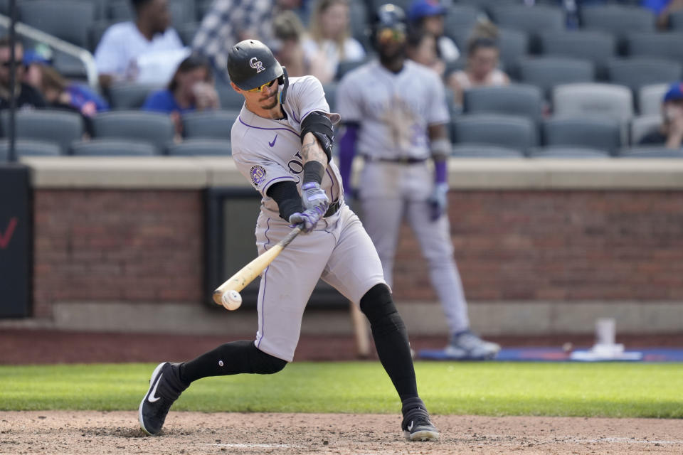 Colorado Rockies' Brenton Doyle hits an RBI single in the ninth inning of a baseball game against the New York Mets, Sunday, May 7, 2023, in New York. (AP Photo/John Minchillo)