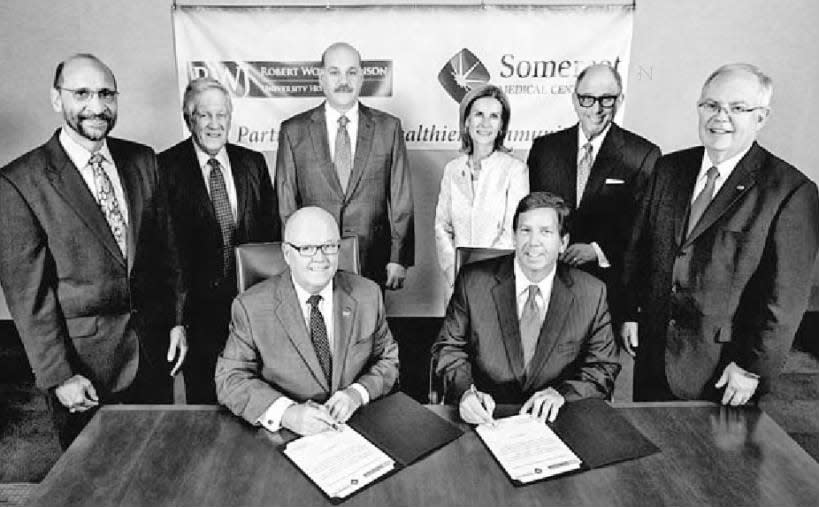 Officials from Robert Wood Johnson University Hospital and Somerset Medical Center at the merger signing ceremony.