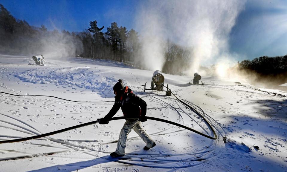 <span>Snowmaking on the slopes begins early in the morning to allow for skiing over the course of the day.</span><span>Photograph: Boston Globe/Getty Images</span>