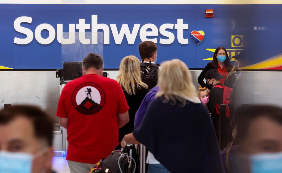 Travelers wait to check-in at the Southwest Airlines ticketing counter at Baltimore Washington International Thurgood Marshall Airport on Oct. 11, 2021.