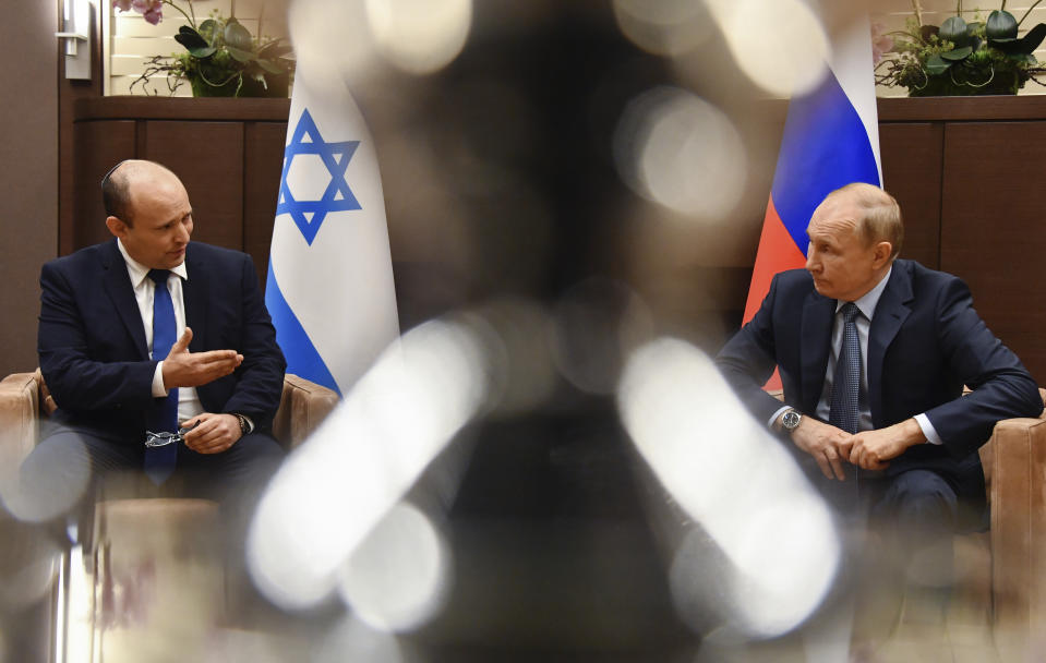 Russian President Vladimir Putin, right, and Israeli Prime Minister Naftali Bennett speak during their meeting in Sochi, Russia, Friday, Oct. 22, 2021. Russian President Vladimir Putin hosted Israeli Prime Minister Naftali Bennett Friday for their first meeting, hailing friendly ties between the two countries. (Evgeny Biyatov, Sputnik, Kremlin Pool Photo via AP)