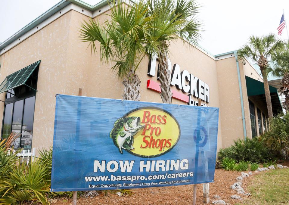 Bass Pro Shops at the Destin Commons has a large hiring banner at the corner of their building.